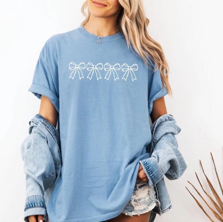 Woman in a blue coquette bow t-shirt