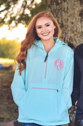 girl wearing a blue monogrammed rain jacket