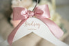 bridesmaid hangers with engraved name and pink bow