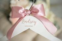 bridesmaid hangers with engraved name and pink bow