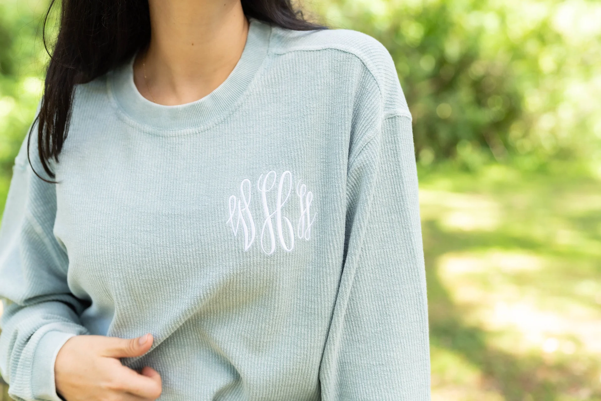 woman wearing a corded monogrammed pullover sweatshirt