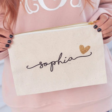 Woman holding a cream custom makeup pouch