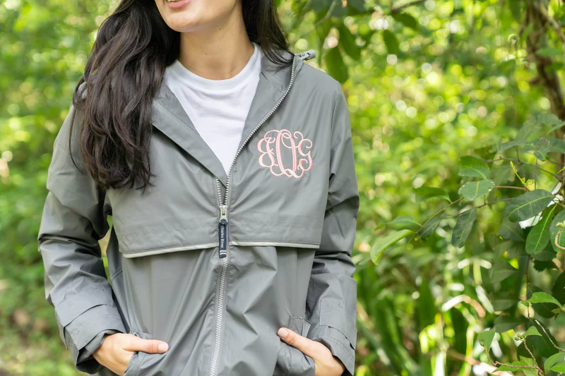 grey rain jacket with pink monogram