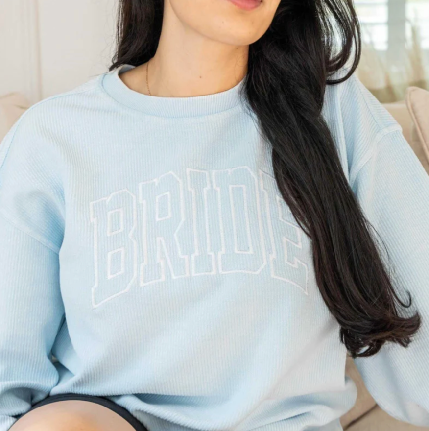 woman wearing a light blue bride sweatshirt