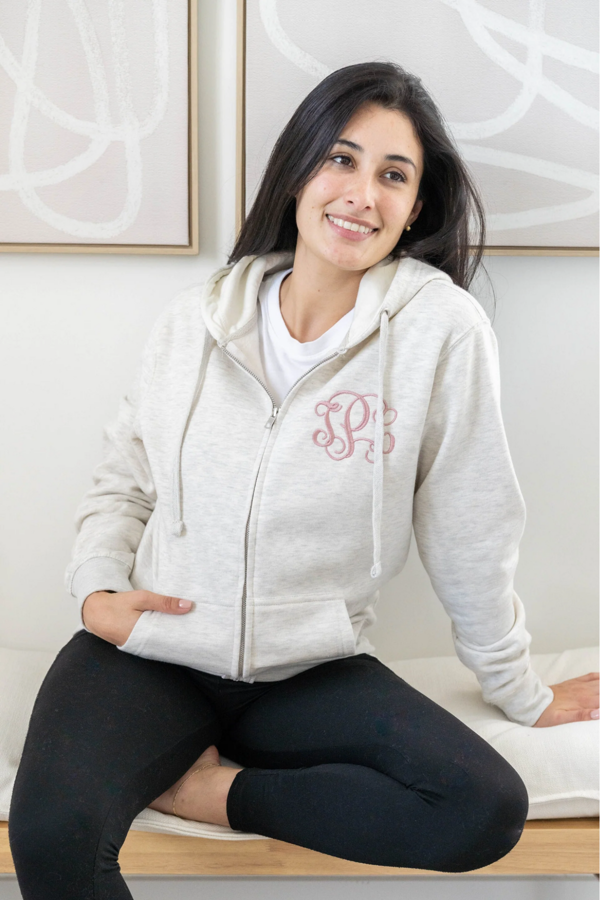 woman wearing a monogrammed hoodie