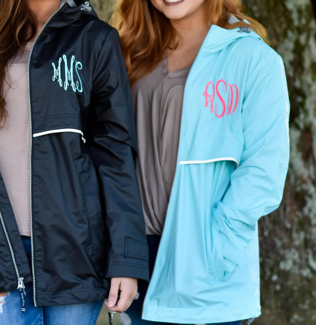 two girls wearing monogrammed rain jackets