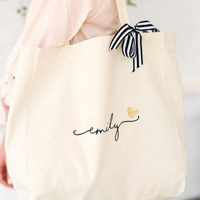 White monogrammed bag on a woman’s shoulder